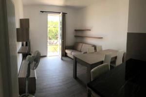a living room with a table and a couch at Casa SamAsia in Varazze