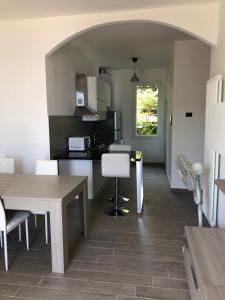 a kitchen with a table and chairs in a room at Casa SamAsia in Varazze +4 photos