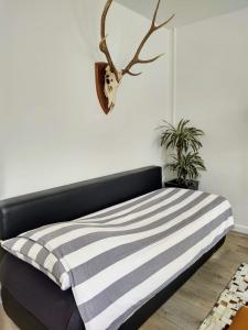 a bed with a black and white striped blanket at Jordaan Canal View Apartment in Amsterdam
