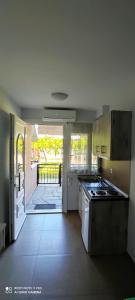a kitchen with an open door to a patio at Aiolos II in Skala Potamias