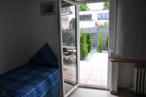 a bedroom with a sliding glass door leading to a patio at Weisenau Plaza in Mainz