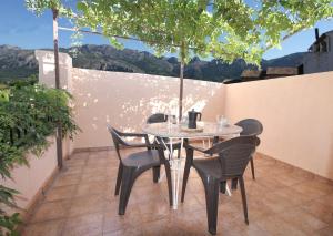 a table and chairs on a patio with a view at LA MUNTANYA - Apartamentos Rural Guadalest in Benimantell