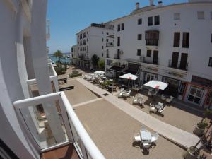 a balcony of a building with tables and chairs at Duquesa Harbour Club Aparthotel in Manilva