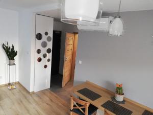 a dining room with a table and a mirror at Kompozytor in Lublin
