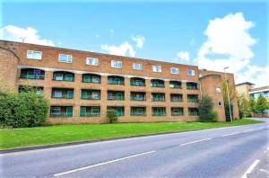 a brick building on the side of a street at Town Centre Studio Flat! in Basingstoke