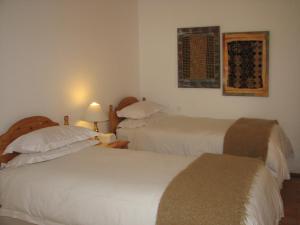 a hotel room with two beds and a window at Toverberg Guest Houses in Colesberg