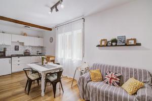 a living room with a couch and a table at Vacation home Korina in Senj