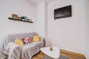 a living room with a couch and a flat screen tv at Vacation home Korina in Senj