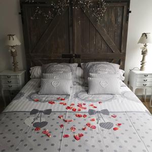 a bed with red roses on it with two night stands at Une affaire de famille in Le Portel