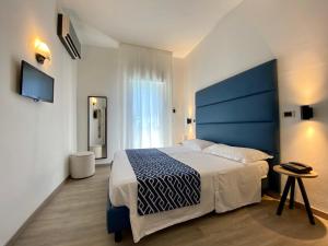 Letto o letti in una camera di Hotel Rombino