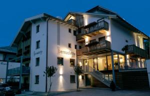 a white building with stairs in front of it at Hotel Garni Bernadette in Serfaus