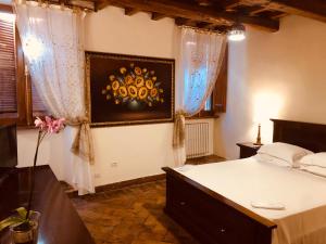 a bedroom with a bed and a painting on the wall at Castle of Glamour XVI century Luxury Apartments in Rome