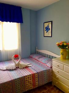 a bedroom with two swans sitting on a bed at SEA-VIEW APARTMENT WITH a TENNIS COURT in Adeje