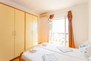 Postel nebo postele na pokoji v ubytování APARTMANI GRBAVAC