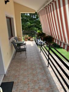 a patio with a table and chairs on a balcony at Apartments Klabjan in Osp