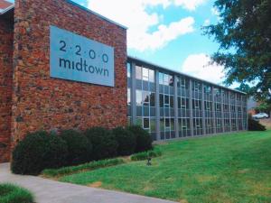 a brick building with a sign on the side of it at Downtown Apartment convenient to all city venues 105 in Greensboro