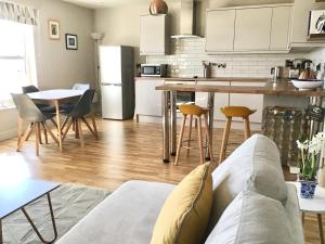 a kitchen and living room with a couch and a table at North Sea View Apartment in Scarborough