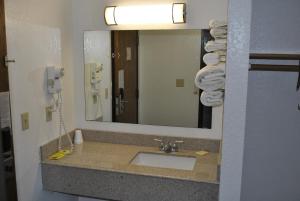 a bathroom with a sink and a mirror at Waconia Inn and Suites in Waconia