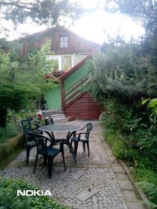 a patio with a table and chairs in front of a building at Apartament z ogrodem in Szczytna