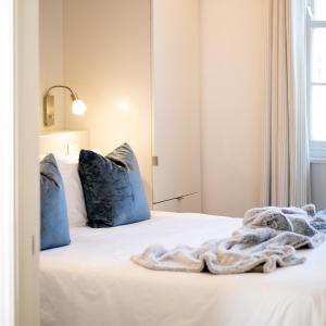 a bed with blue pillows and a blanket on it at Purple House Accommodations in Cape Town