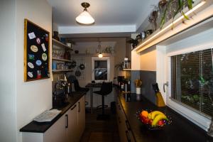 a kitchen with a bowl of fruit on a counter at Appartement Fallnhauser - Adults only in Hallstatt