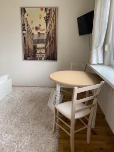 a table and a chair in a room at LieblingsOrt in Neusiedl am See