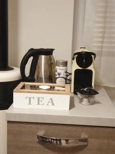 a tea set on a shelf with a tea kettle and a coffee maker at Am Meer in Ladispoli