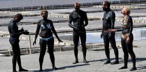 a group of people in wet suits standing on the beach at Апартаменти Бриз 1 in Pomorie