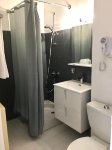 a bathroom with a shower and a toilet and a sink at Hostellerie Saint Benoît in Aniane +40 photos