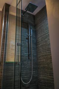 a shower with a glass door in a bathroom at Copper Oven apartments in Arbroath