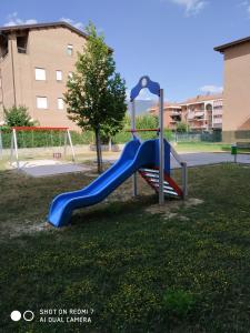 a playground with a blue slide in a park at Appartamento SERGIO LUXURY CENTRO parking free in Santa Maria degli Angeli