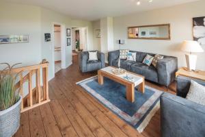 a living room with a couch and a table at NTBM36001-Binnenseeblick in Neue Tiefe Fehmarn