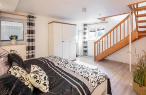 a bedroom with a bed and a staircase at NTBM36001-Binnenseeblick in Neue Tiefe Fehmarn