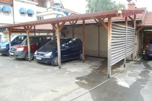 a carport with cars parked in a parking lot at RI-VAL in Valandovo
