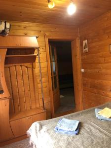 a bedroom with a bunk bed in a log cabin at Skarbivka in Vorokhta