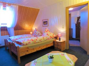 a bedroom with a bed and a table in it at Ferienhof Cohrs in Bispingen