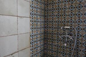 a bathroom with a shower with a tile wall at Country House Casa Lucia in Vodnjan