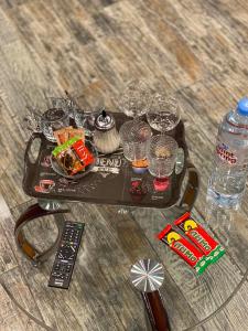 a tray of food and drinks and a remote control at Мини отель Нумера in Moscow