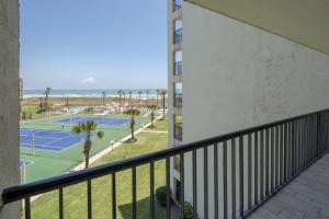 a balcony of a building with two tennis courts at Saida in South Padre Island