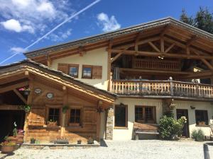 a large wooden house with a balcony at L'Atelier in Les Contamines-Montjoie