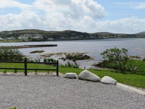 two rocks on the side of a body of water at Sea breeze Cottage in Dungloe