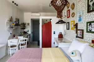 ein Schlafzimmer mit einem Bett und eine Küche mit einer roten Tür in der Unterkunft Pefkos Eye in Pefki Rhodes