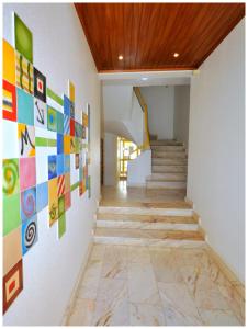 a hallway with colorful art on the walls at Apartamentos Capitolina in Quarteira