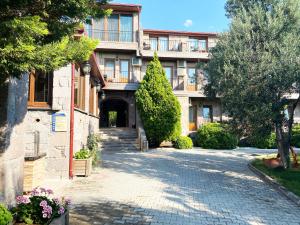 um edifício de apartamentos com uma rua de calçada em Assos Park Hotel em Behramkale