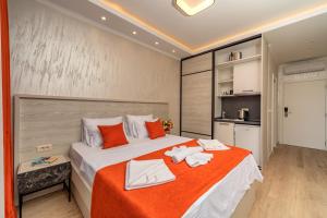 a bedroom with a large bed with towels on it at Luxury Apartments Queen in Petrovac na Moru