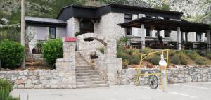 a building with a stone staircase in front of it at Vinarija Andjusic in Dračevo +6 photos