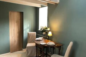 a dining room with a table and chairs and a window at Barns Bothy in Peebles