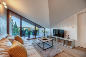 a living room with a couch and a tv at Luxury Apartments Queen in Petrovac na Moru
