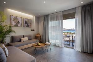 a living room with a couch and a table at Costa D' Ifesto in Agios Ioannis Kaspaka