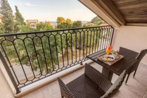 a balcony with a table and chairs and a view at Luxury Apartments Queen in Petrovac na Moru